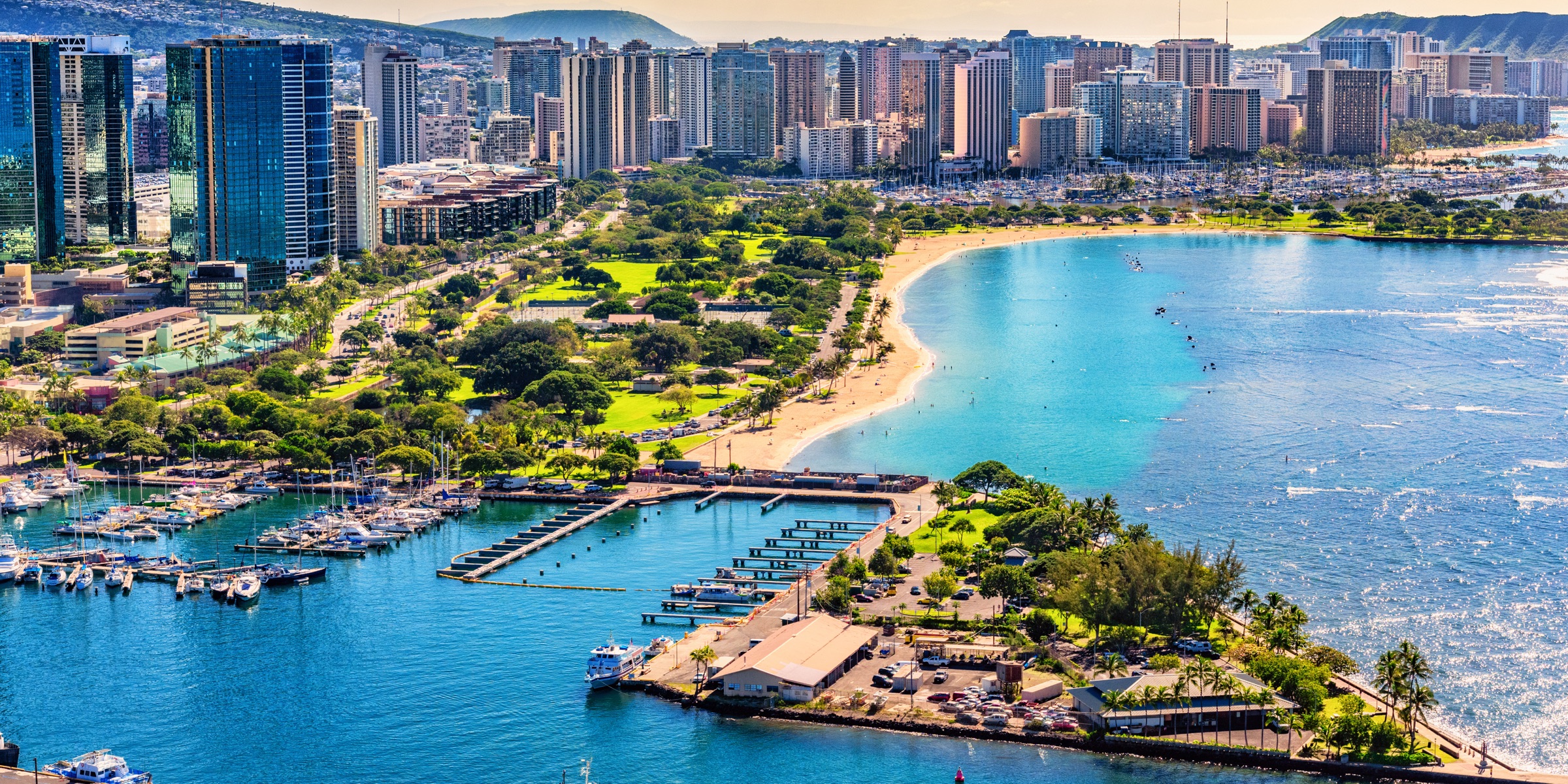 Aerial view of Magic Island and Ala Moana Beach Park with the Ala Moana and Kakaako condo skyline behind